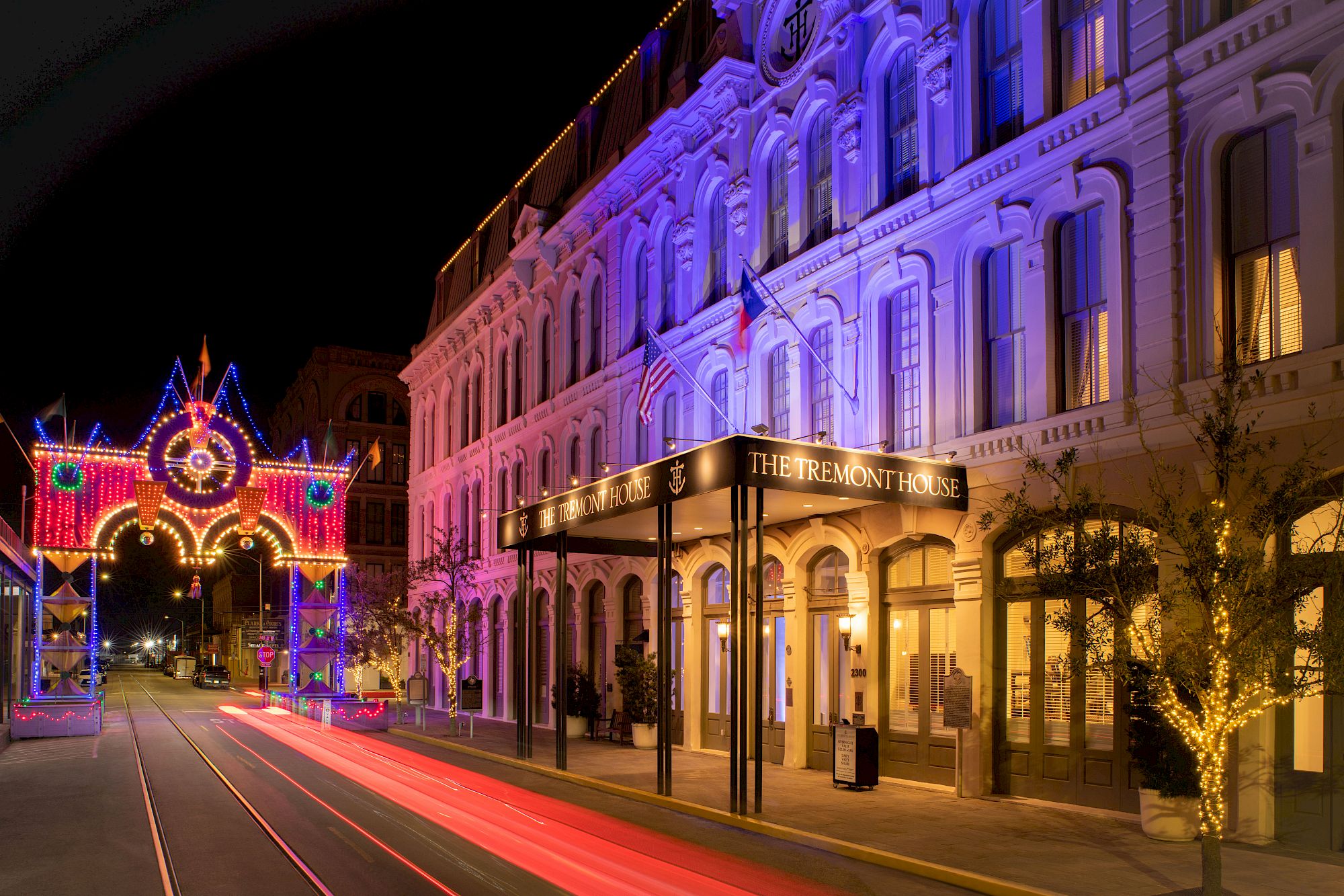 a photo of the front of the Tremont House Hotel with a colorful arch in the background