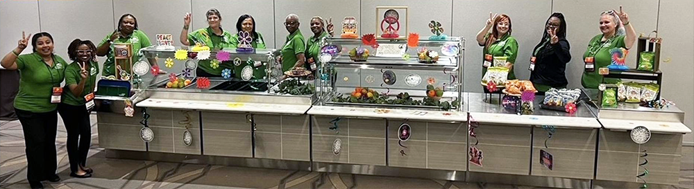 Klein ISD members smiling in front of a decorated lunch counter